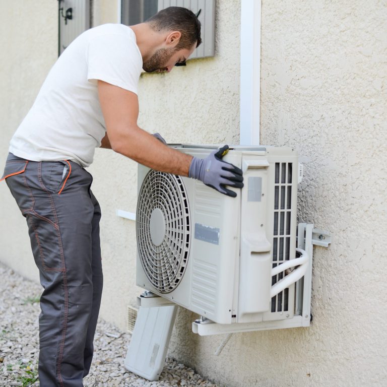 contractor-performing-hvac-service-on-private-house contractor performing hvac service on private house